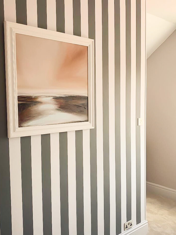 Beach themed art work and stripy bedroom wall in period semi in Hale