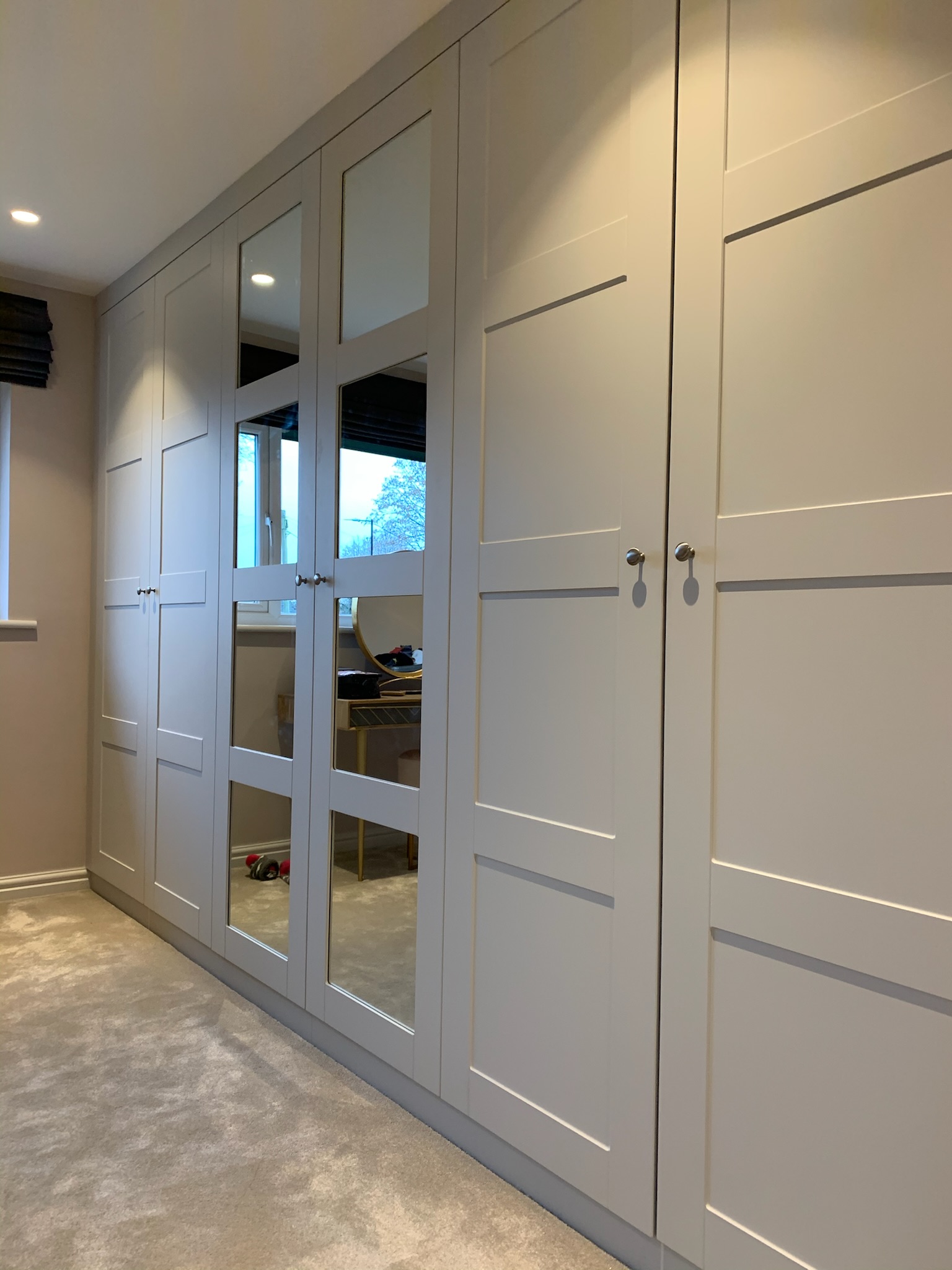 Contemporary wardrobes with long mirrors in Hale Barns home