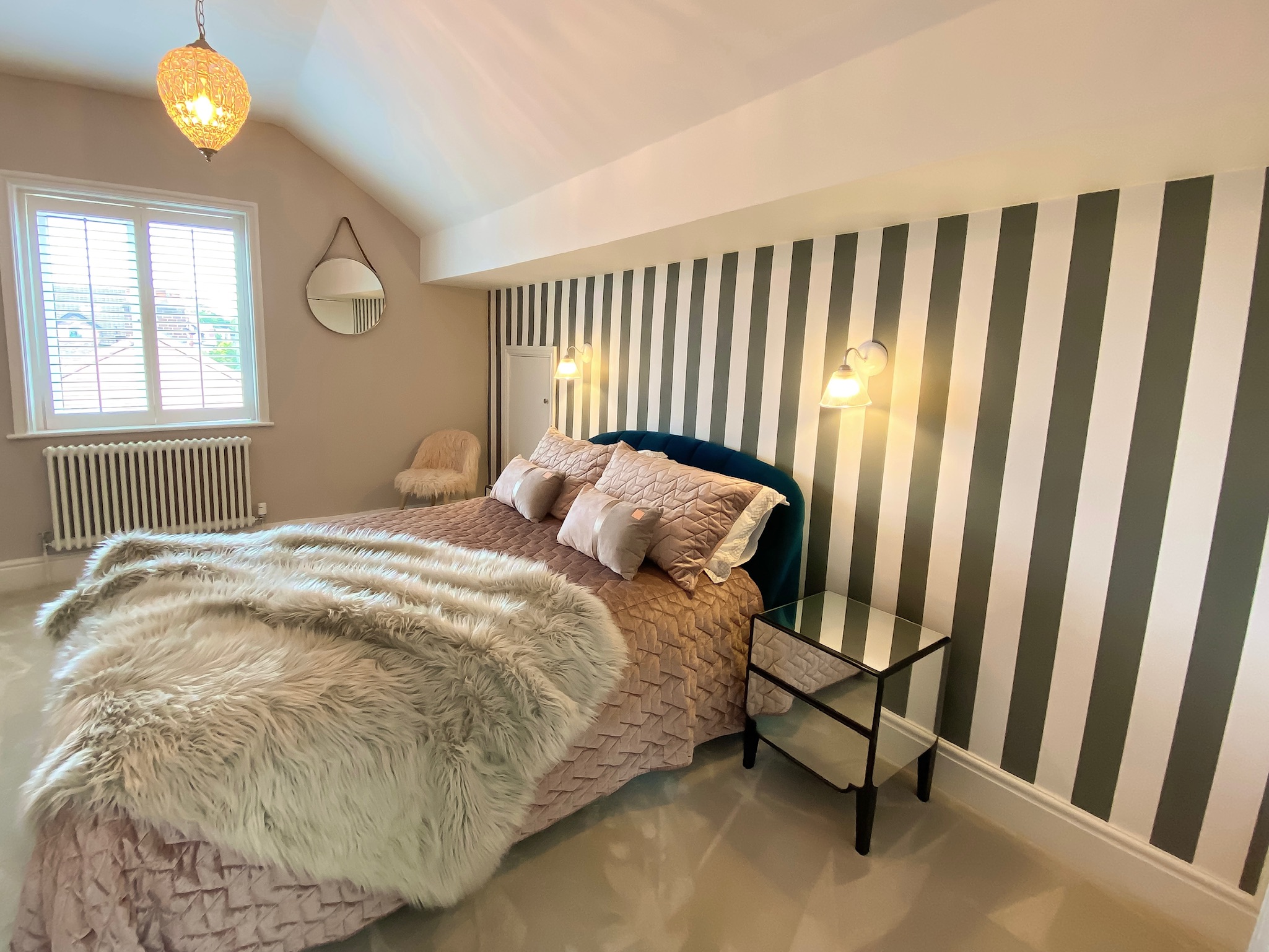 Striped bedroom wallpaper with comfy luxury bed at period semi in Hale