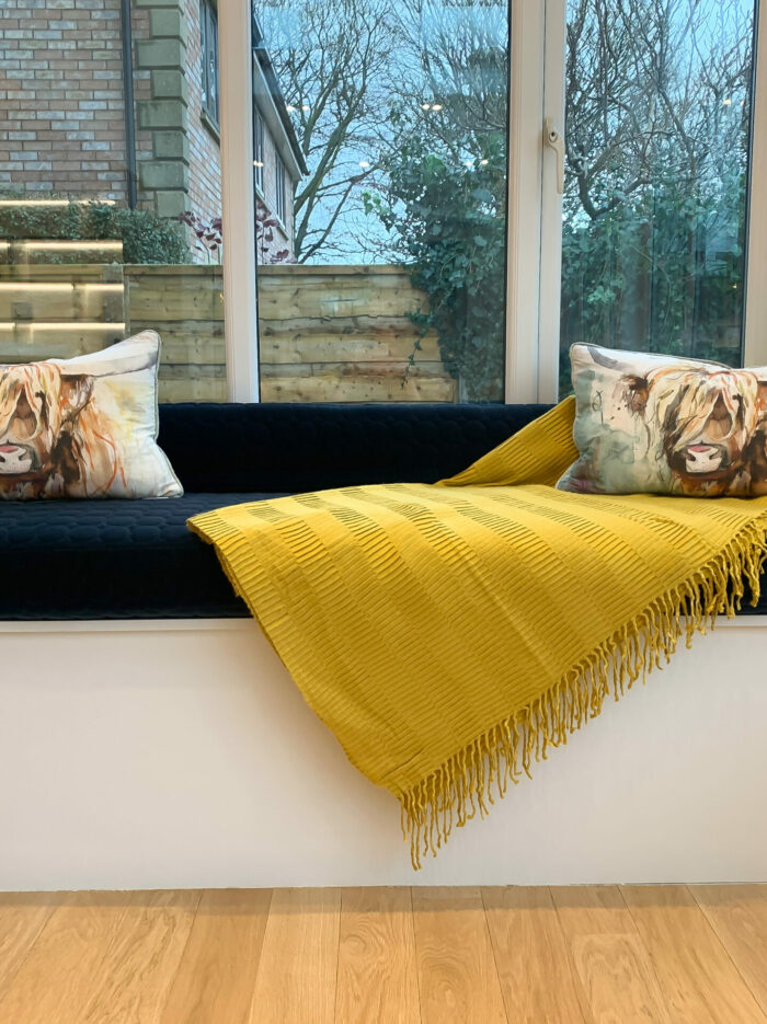 Modern contemporary window seat with cow cushions in High Leigh